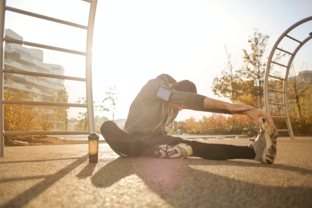 Man stretches before running for summer exercise